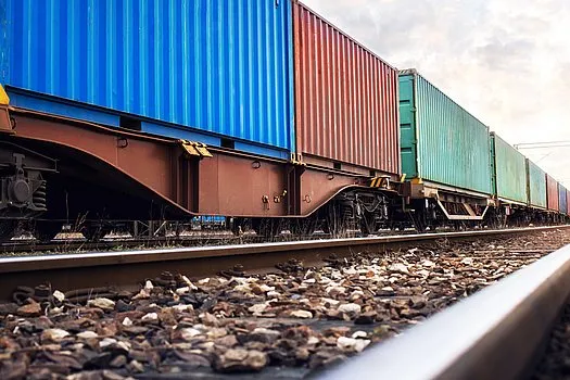 Train wagons carrying cargo containers for shipping companies