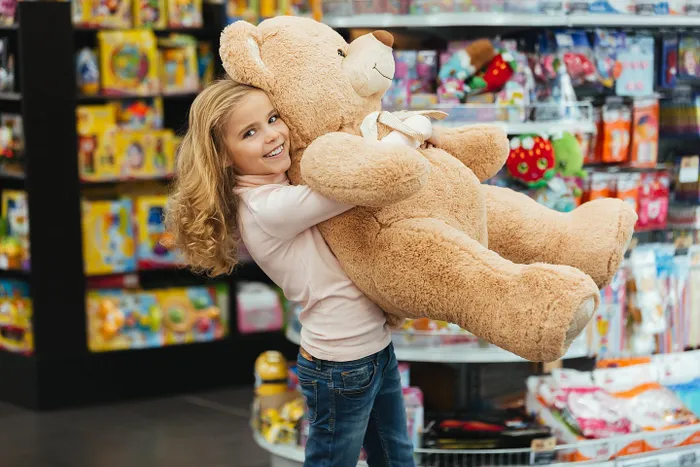 A little girl and a toy bear